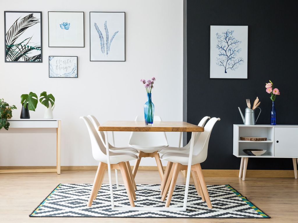 A dining room table in a well staged room