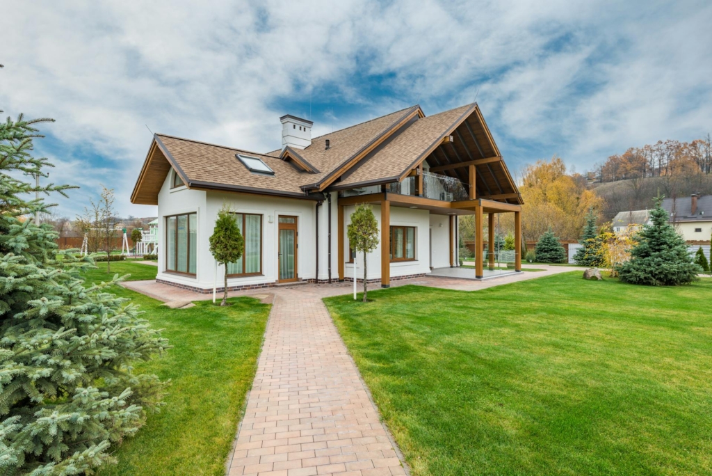 A house with a well-manicured lawn and beautiful skyline