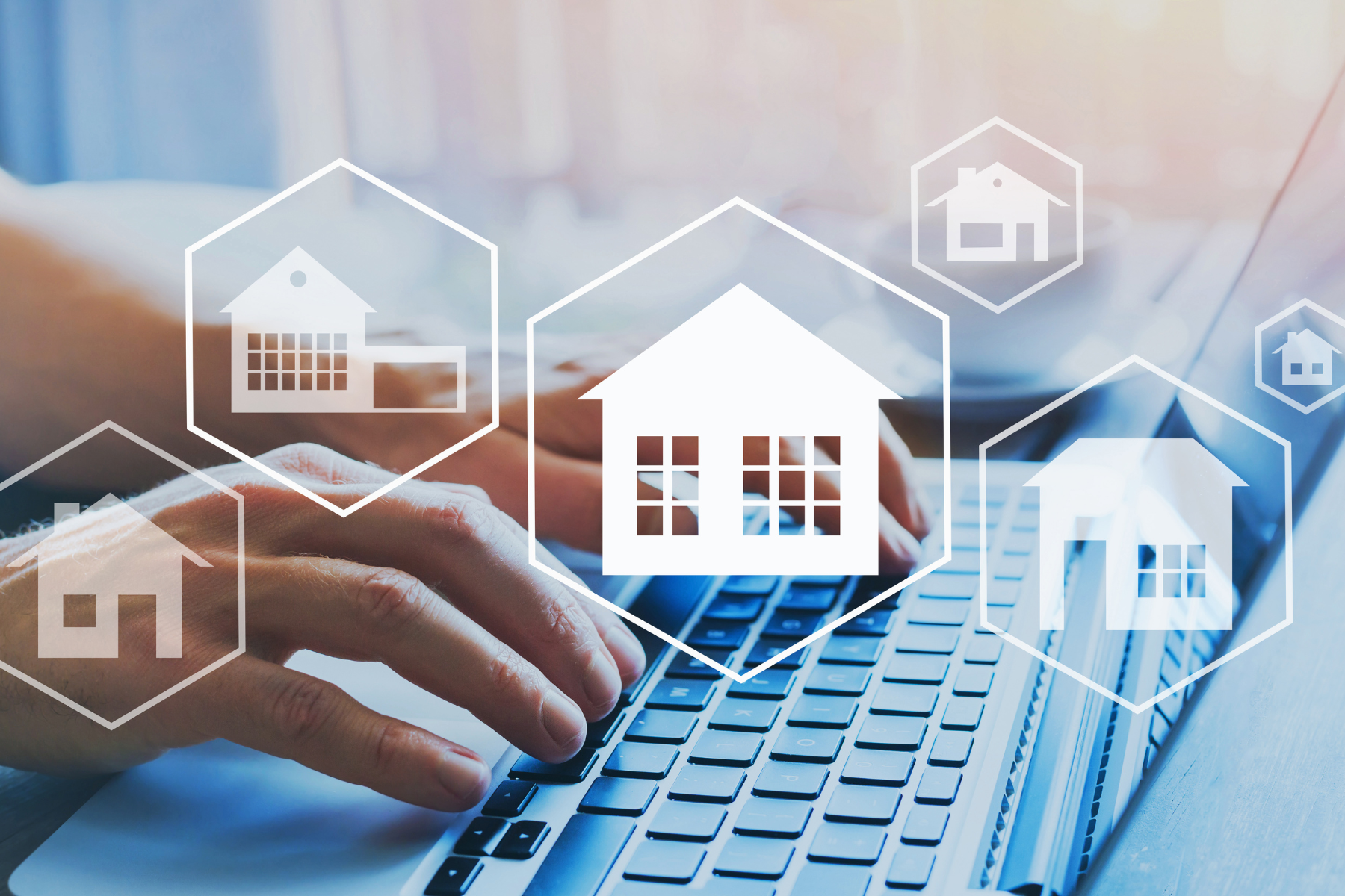 A person typing on a laptop. House icons implying a home search.