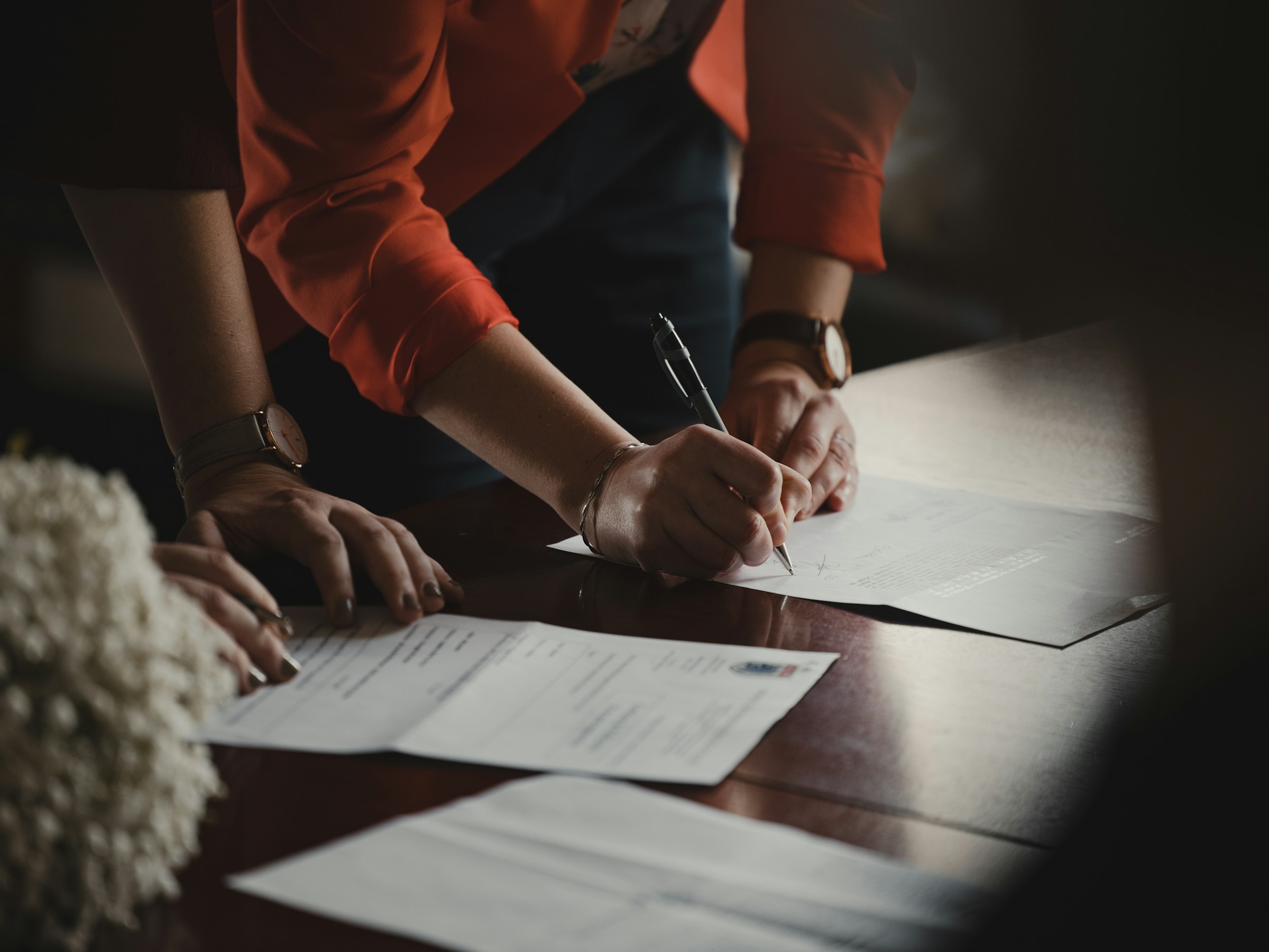 A person signing papers.