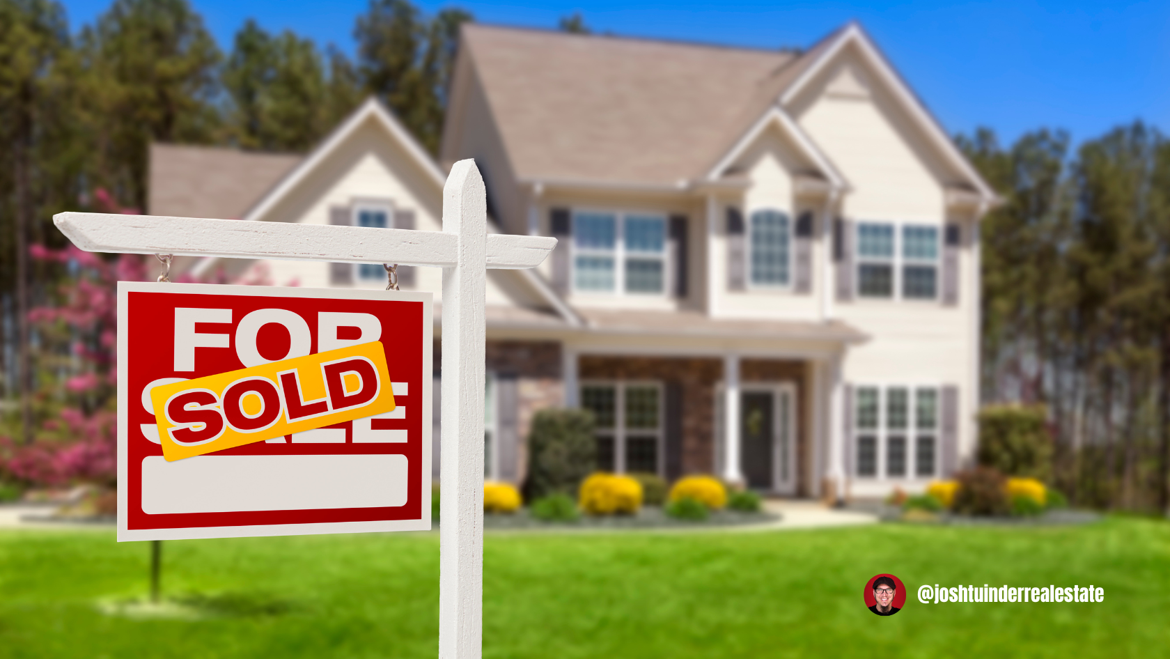 A red and white "For Sale" sign with a large yellow "SOLD" sticker is displayed in the foreground, indicating a recently sold home. Behind it, a large, two-story suburban house with beige siding, multiple windows, and manicured landscaping is slightly blurred. The background features tall trees and a clear blue sky. In the bottom right corner, a logo and the handle "@joshtuinderrealestate" are visible.